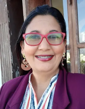 A bird sitting on a nest of eggs.