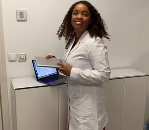 A bird sitting on a nest of eggs.