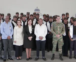 A bird sitting on a nest of eggs.