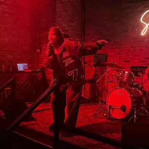 A bird sitting on a nest of eggs.