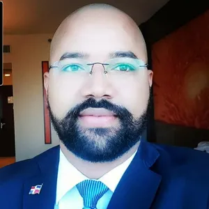 A bird sitting on a nest of eggs.