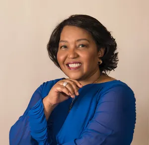 A bird sitting on a nest of eggs.