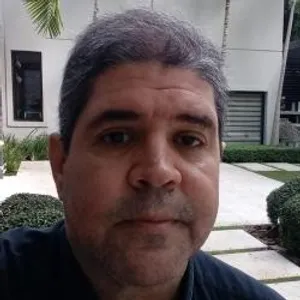 A bird sitting on a nest of eggs.