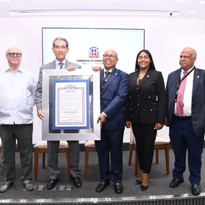 A bird sitting on a nest of eggs.