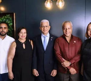 A bird sitting on a nest of eggs.