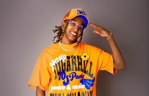 A bird sitting on a nest of eggs.