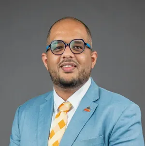 A bird sitting on a nest of eggs.