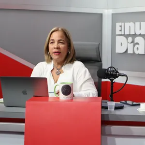 A bird sitting on a nest of eggs.