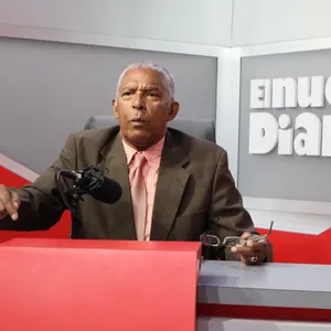 A bird sitting on a nest of eggs.