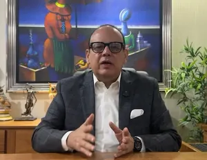 A bird sitting on a nest of eggs.