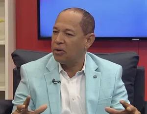 A bird sitting on a nest of eggs.