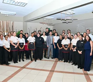 A bird sitting on a nest of eggs.