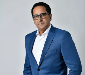 A bird sitting on a nest of eggs.